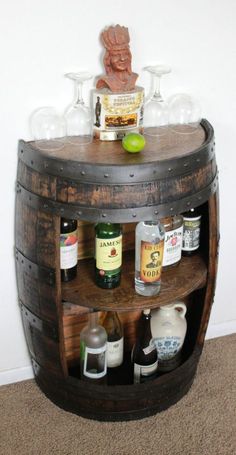 a wooden barrel shelf with bottles and glasses on top