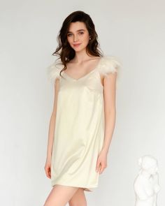 An elegant and minimalist dress made of satin, complemented by detachable straps with soft feathers, look romantic and at the same time very comfortable. We would be glad to assist you with choosing the right size and even use your individual measurements so that the product fits you perfectly, at no additional cost. Details: Contains: Dress, Detachable Straps Material: Satin Lining: Satin Length: Short, Long Hardware: Hypoallergenic Stainless Steel Colour: Almond Milk, Nude Collection: Silenzio Elegant Dresses With Feather Trim And Spaghetti Straps, Feathered Dresses For Wedding Night, Satin Dresses With Feather Trim, Elegant Wedding Night Dress With Feather Trim, Elegant Feather Trim Dress For Wedding Night, Cream Elegant Sleep Dress, Minimalist Dress, Garment Care Labels, Minimalist Dresses