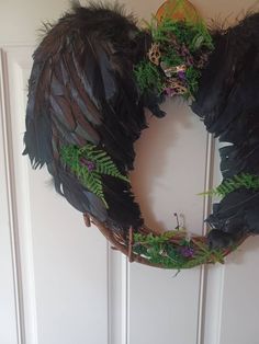 a wreath made out of feathers and plants