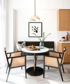 a table with chairs around it in the middle of a room