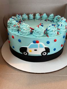 a police cake with blue frosting and sprinkles on the icing