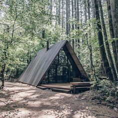 a tent in the woods with stairs leading up to it