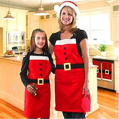 two women dressed up as santa clause and mrs peppermint for christmas day, standing next to each other