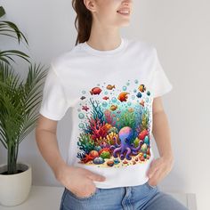 "Dive into the beauty of the ocean with our watercolor underwater life unisex t-shirt. This tee features a stunning depiction of vibrant coral reefs and a variety of playful fish, bringing the wonder of the sea to your wardrobe. Perfect for ocean enthusiasts and anyone who appreciates unique, artistic apparel. Made with comfortable materials, this shirt is ideal for everyday wear or as a special gift. Embrace the charm of the deep sea with this one-of-a-kind ocean-themed t-shirt! We utilize the Fish Shirt Design, Watercolor Coral Reef, Fall Board, Underwater Painting, Underwater Theme, Fish Shirt, Coral Watercolor, Underwater Life, Artist Outfit