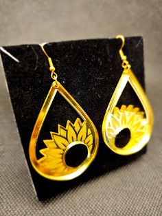 Unique laser crafted engraved gold mirror acrylic sunflower drop earrings. Brighten your day with these quality but lightweight Sunflower earrings. Contact us for any personal requests. We pride ourselves on prompt service. Any questions, please get in touch. Elegant Sunflower Design Earrings, Laser Cut Teardrop Jewelry As A Gift, Gold Sunflower Dangle Jewelry, Mirrored Acrylic Earrings, Acrylic Sunflower, Yellow Flower Shaped Jewelry With Sunflower Print, Yellow Sunflower Design Flower Earrings, Yellow Sunflower Dangle Jewelry, Gold Mirror Acrylic