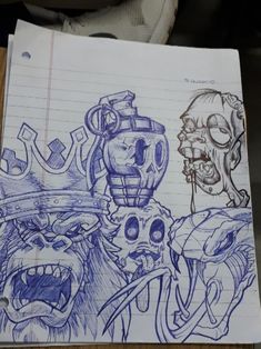 a notebook with some drawings on it and an image of two monsters in the background