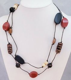 This is a Chico's Brand Red Moon Boho Mixed Beaded Venetian Glass Bib Necklace. The metal extender is a silver tone metal. The necklace measures 25" at the longest, it is adjustable and weighs 1.5 oz. It is NWT N17 Items are shipped from a smoke-free home. Photos are part of the listing so PLEASE look at all pictures. And if an item is Sterling Silver it may tarnish in time, I suggest you buy a Polishing Cloth (one brand is called SUNSHINE CLOTH) and take care of it, Wearing it in water will als Brown Long Necklace With Colorful Beads For Gift, Gift Brown Long Necklace With Colorful Beads, Gift Long Brown Necklace With Colorful Beads, Bohemian Red Necklace With Black Beads, Adjustable Long Necklace With Black Beads, Casual Red Beaded Chain Jewelry, Red Multi-strand Necklace With Wooden Beads, Brown Necklaces With Black Beads For Beach, Multi-strand Red Necklace With Wooden Beads