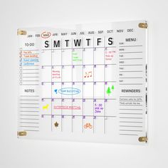 a white calendar with the words smtwtfs written on it, hanging on a wall