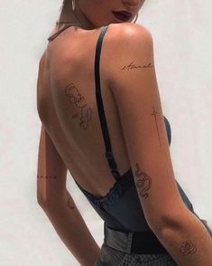 the back of a woman's body with tattoos on her upper and lower half