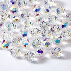 many different colored diamonds on a white surface