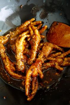 some fried food is being cooked in a frying pan