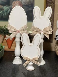 two white bunny ears with bows on them