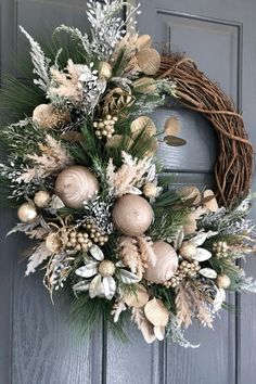 a wreath on the front door with pine cones and berries