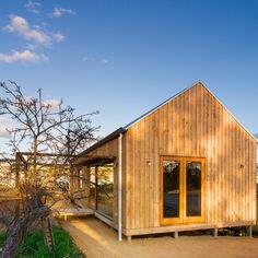 a small wooden building sitting on top of a dirt field