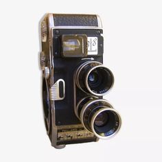 an old fashioned camera with two lenses attached to the front and back of it, against a white background