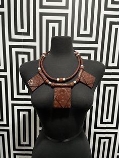 This necklace is crafted with genuine leather from Mali. Unisex and handmade, each piece is one-of-a-kind and may have slight imperfections due to the manufacturing process. Layer it with other necklaces to create a unique look. Vintage Adjustable Leather Necklace, Adjustable Leather Vintage Necklace, Traditional Leather Jewelry For Festival, Vintage Leather Necklace As Gift, Vintage Leather Necklace For Gift, Artisan Brown Leather Necklace, Brown Leather Necklace For Gifts, Brown Leather Pendant Necklace, Traditional Handmade Leather Jewelry