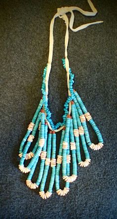 "This is a pawn item . 8 jaculas hanging from a leather turquoise necklace. Adjustable length. Each Jacula hangs about 5 inches. This is a Good Price! If you have any questions, please send me a convo. What is a Jacula...A traditional Pueblo jewelry adornment, a jacula is two loops of heshi that were originally earrings and sometimes fastened to the bottom of a stone necklace as a pendant-like attachment. Jacula is Navajo for \"ear string\". The Navajo spelling is the most commonly used version Traditional Turquoise Necklace With Dangling Beads, Artisan Turquoise Necklaces With Dangling Beads, Southwestern Necklaces With Dangling Beads, Southwestern Necklaces With Dangling Beads And Adjustable Fit, Artisan Turquoise Necklace With Dangling Beads, Southwestern Necklace With Dangling Beads And Adjustable Fit, Traditional Turquoise Jewelry With Dangling Beads, Traditional Turquoise Single Strand Jewelry, Unique Turquoise Beaded Necklaces With Dangling Beads