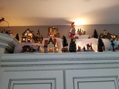 a shelf filled with lots of christmas decorations on top of it's mantles