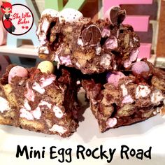 several pieces of chocolate rocky road on a plate with the words mini egg rocky road