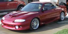 a red sports car parked in front of a house