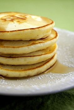 a stack of pancakes sitting on top of a white plate