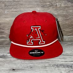 Our Pvc Patch Is A Waterproof, Rugged, And Clean Looking Design. You Can Bet That This Patch Will Look Vibrant For Years To Come. We Only Use The Highest Quality Products And Headwear. We Believe That Our Pvc Patches Beat Out Any Other Type Of Patch Offered On A Hat. Design: Arkansas Razorbacks Jumping Hog Hat: Decky Color: Red/ White Soft-Structured, Five-Panel, High-Profile 70/30 Cotton/Nylon Adjustable Plastic Snapback Slight Curve, Is Adjustable Either Way Hat Size: 7 - 7 3/4 University Red Casual Snapback Hat, Casual University Red Snapback Hat, Red Collegiate Hat For Streetwear, Collegiate Red Snapback Hat, Collegiate Red Baseball Cap, Red Collegiate Baseball Cap, Red Snapback Hat With Visor For Fans, Red Snapback Trucker Hat For Outdoor, Red Collegiate Cap