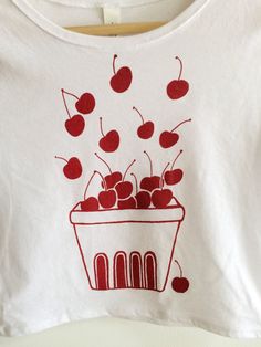 Hand Drawn and Hand Printed! This is a screen printed crop top with a hand drawn basket filled with cherries! It's perfect for summer! The shirt shown here is white and is printed in red ink. These are more of a juniors' sized fit! // PROCESS: All of our items are individually hand printed by either me or my dad, which can lead to slight variations in placement. The ink is heat cured and will not fade over time. Since our items are printed to order, there is a 1-2 week processing time before shi Hand Printed White T-shirt For Summer, White Hand-printed T-shirt For Summer, White Hand Printed T-shirt For Summer, Casual White Hand-printed Top, White Cherry Print T-shirt For Summer, Cherry Crop Top, Cherry Shirt, Printed Crop Top, Fruit Print