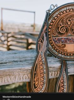 a brown and black purse sitting on top of a wooden bench