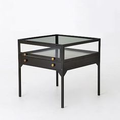 an end table with two drawers and glass top on the bottom, against a white background