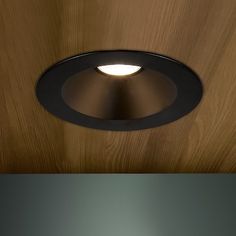 two different views of a ceiling light with wood paneling on the wall and below