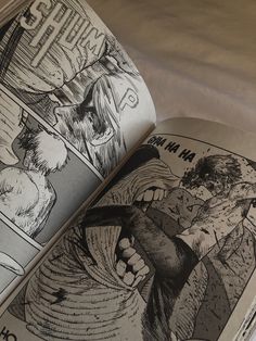 an open comic book with black and white illustrations