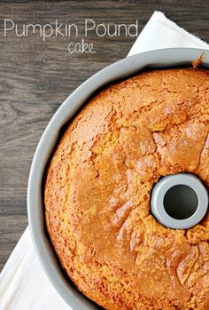 a pumpkin pound cake in a pan on top of a white napkin and wooden table