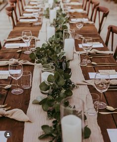 a long table is set with candles and place settings