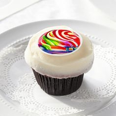 a cupcake with white frosting on a plate