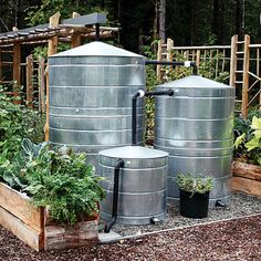 several large metal tanks in a garden area