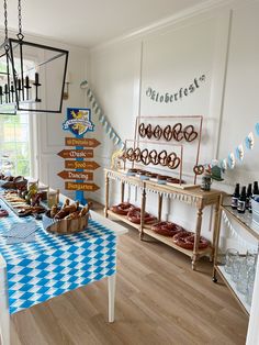 a blue and white checkered table cloth is in front of a buffet with food on it