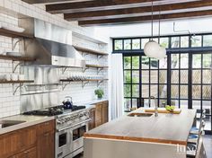 a kitchen with an oven, stove and sink