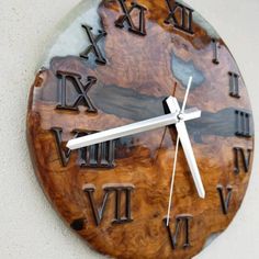 a wooden clock with roman numerals on the face and numbers painted on it