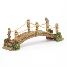 a small wooden bridge with two birds on it