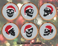 six cross stitch christmas ornament designs with skulls in santa's hats on them