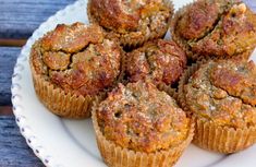 a white plate topped with muffins on top of a wooden table