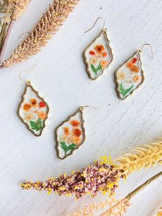 Pressed Wild Flower Earrings Multi Flower Earrings Resin | Etsy Bohemian Dangle Earrings With Pressed Flowers, Bohemian Pressed Flowers Drop Earrings, Gold Flower Earrings, Nature-inspired, Bohemian Drop Earrings With Pressed Flowers, Nature-inspired Gold Flower Earrings, Nature-inspired Dangle Earrings With Flower Charm, Gold Pressed Flowers Dangle Earrings, Nature-inspired Gold Flower Earrings With Pressed Flowers, Nature-inspired Gold Flower Earrings With Charm