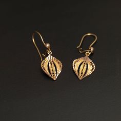 Enhance your style with these elegant and artisan-crafted 14k gold filigree leaf earrings. Each earring features etched solid gold with delicate filigree detailing in between, creating a captivating leaf, fan, or teardrop shape. These exquisite earrings weigh 2.4 grams and showcase meticulous craftsmanship. The leaf-shaped design measures approximately 10.85mm x 7.55mm, with the ear wires included, providing a total length of 21.5mm. Treat yourself or someone special to these unique and versatil Delicate Earrings With Intricate Design, 14k Gold Filigree Earrings For Anniversary, Elegant 14k Gold Earrings With Intricate Design, Dainty Yellow Gold Filigree Jewelry, 14k Yellow Gold Earrings With Intricate Design, Elegant Engraved 14k Gold Earrings, Dainty Filigree Jewelry For Formal Occasions, 14k Gold Filigree Earrings For Wedding, 14k Gold Drop Earrings With Intricate Design