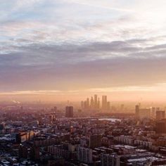 an aerial view of a city at sunset