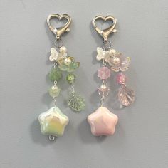 three charms with hearts and flowers hanging from them