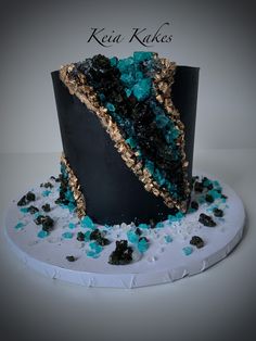 a black cake with blue and gold decorations