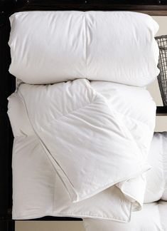 pillows stacked on top of each other in front of a wall