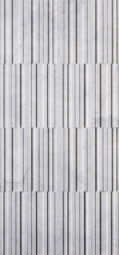 a white marble wall with vertical lines on it