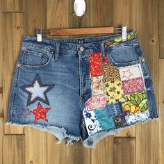 a pair of jean shorts with patchwork and stars on them