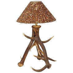 an antler lamp with a brown shade on it's base and a white background